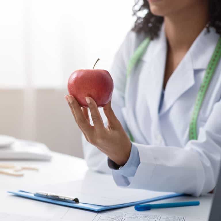 Doctor gifting apple at Nutrition Counseling Service in Tampa